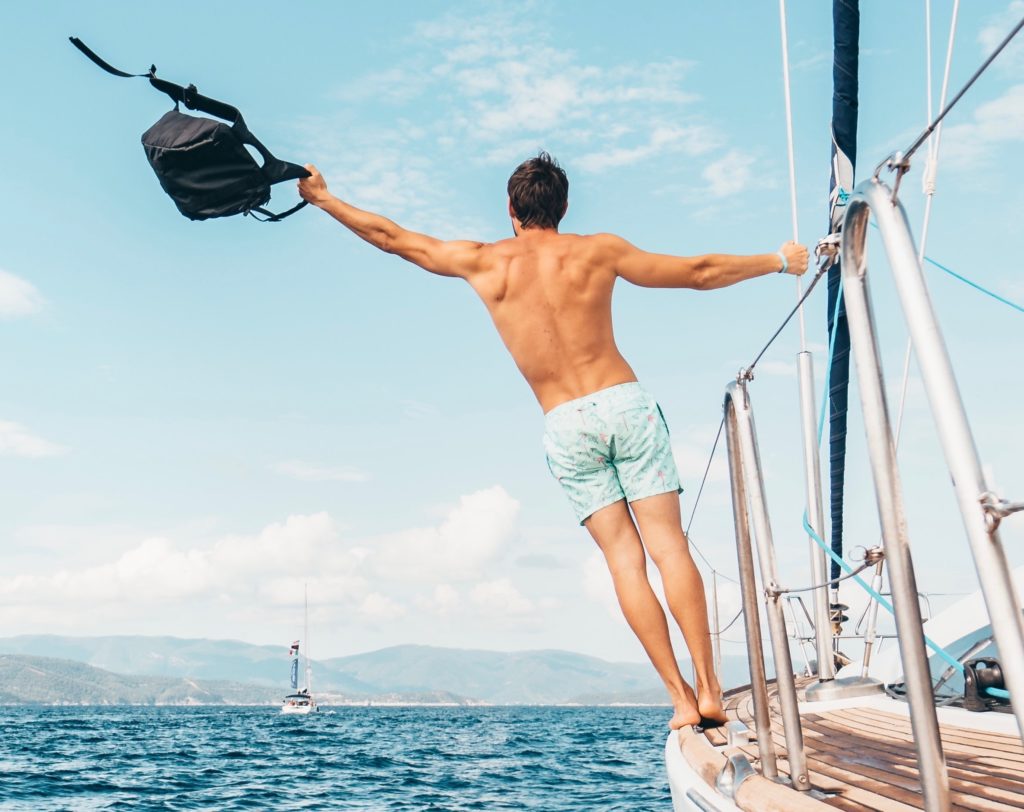 Man on a yacht with a bag